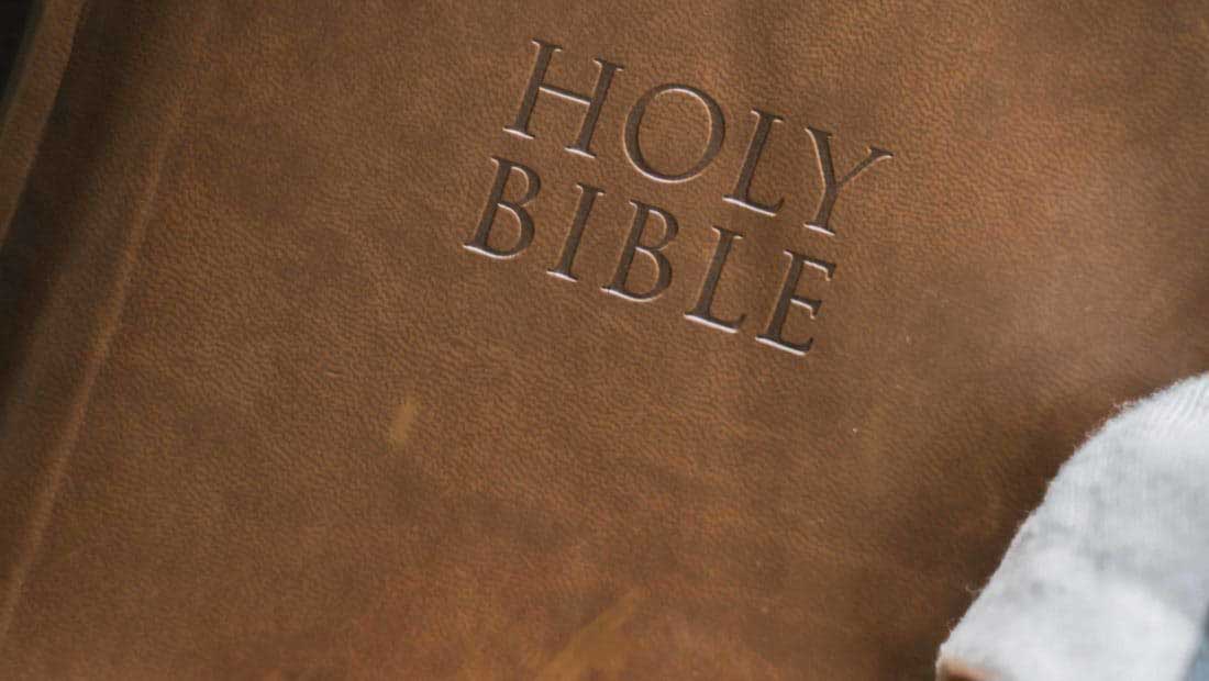 A close up of someone holding a Bible.